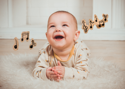 Ein kleines Baby hört auf der Decke Musik